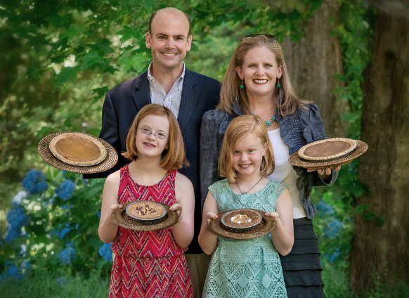 The Darden's family holding pies